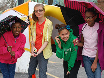 Photo of kids holding umbrellas