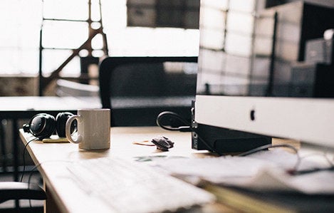 Photo of computer and headphones on a desk