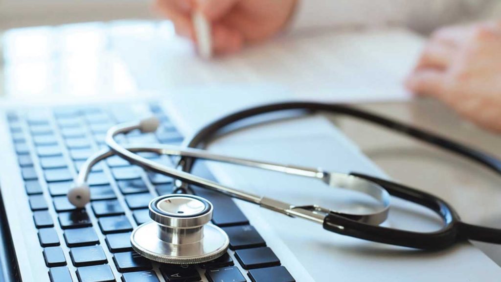 Stethoscope resting on a laptop keyboard