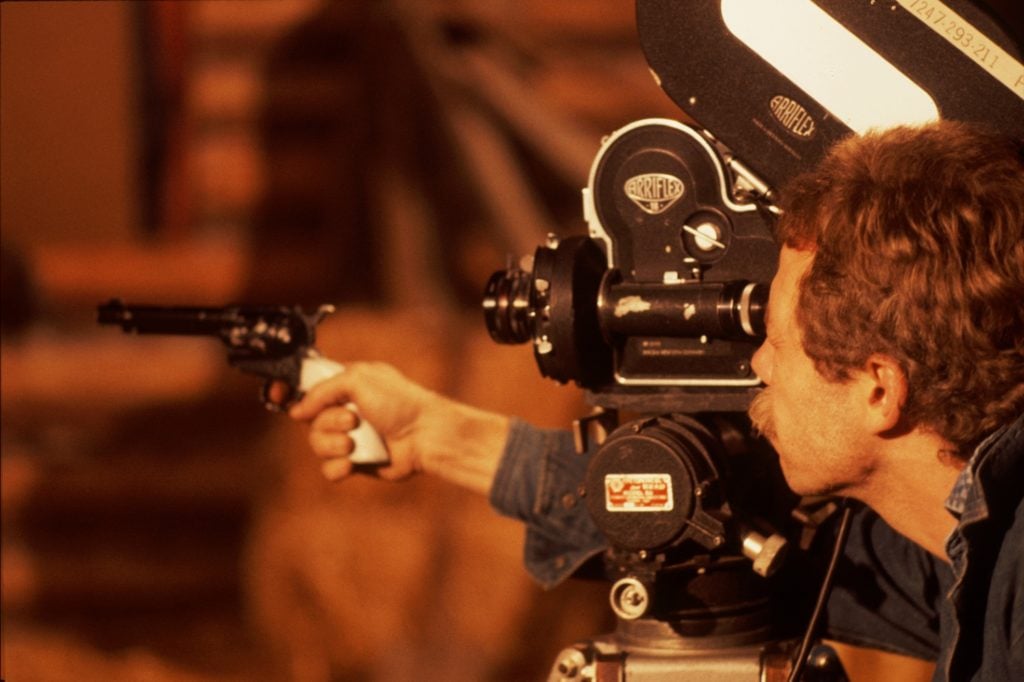 Chuck Statler behind camera with a gun