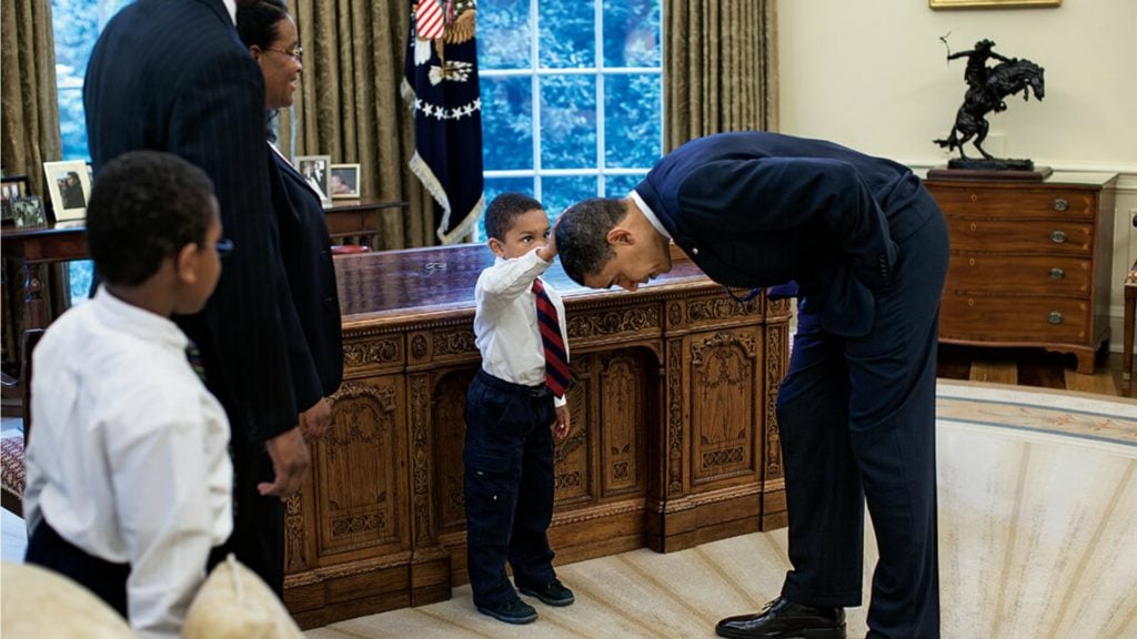 Barack Obama leans down for child to touch his hair