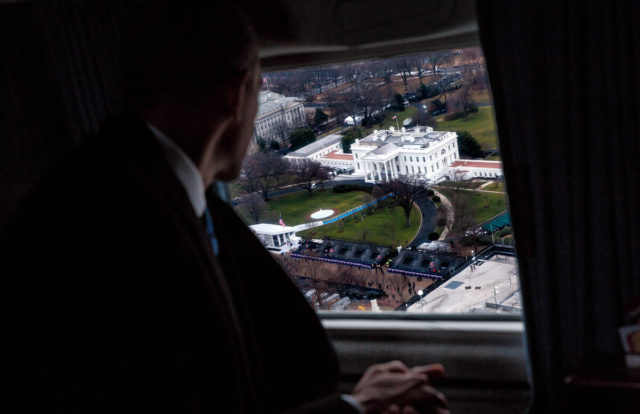 Barack Obama looks out the window at the White House