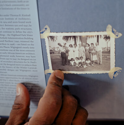 James Garrett points to a photo of his family with renowned St. Paul architect Cap Wigington 