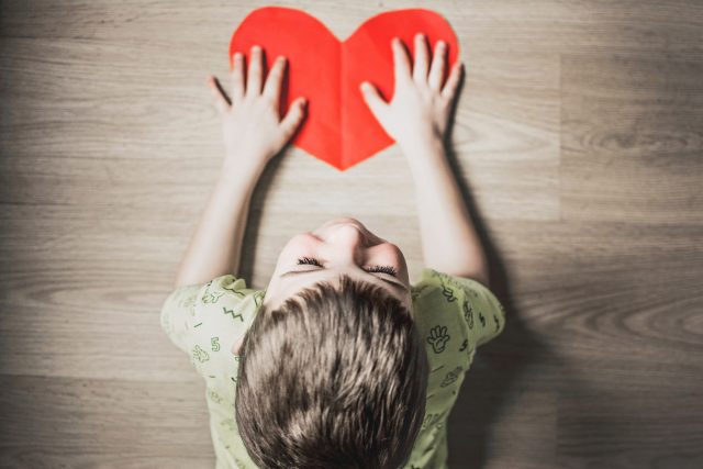 Young boy with cutout heart