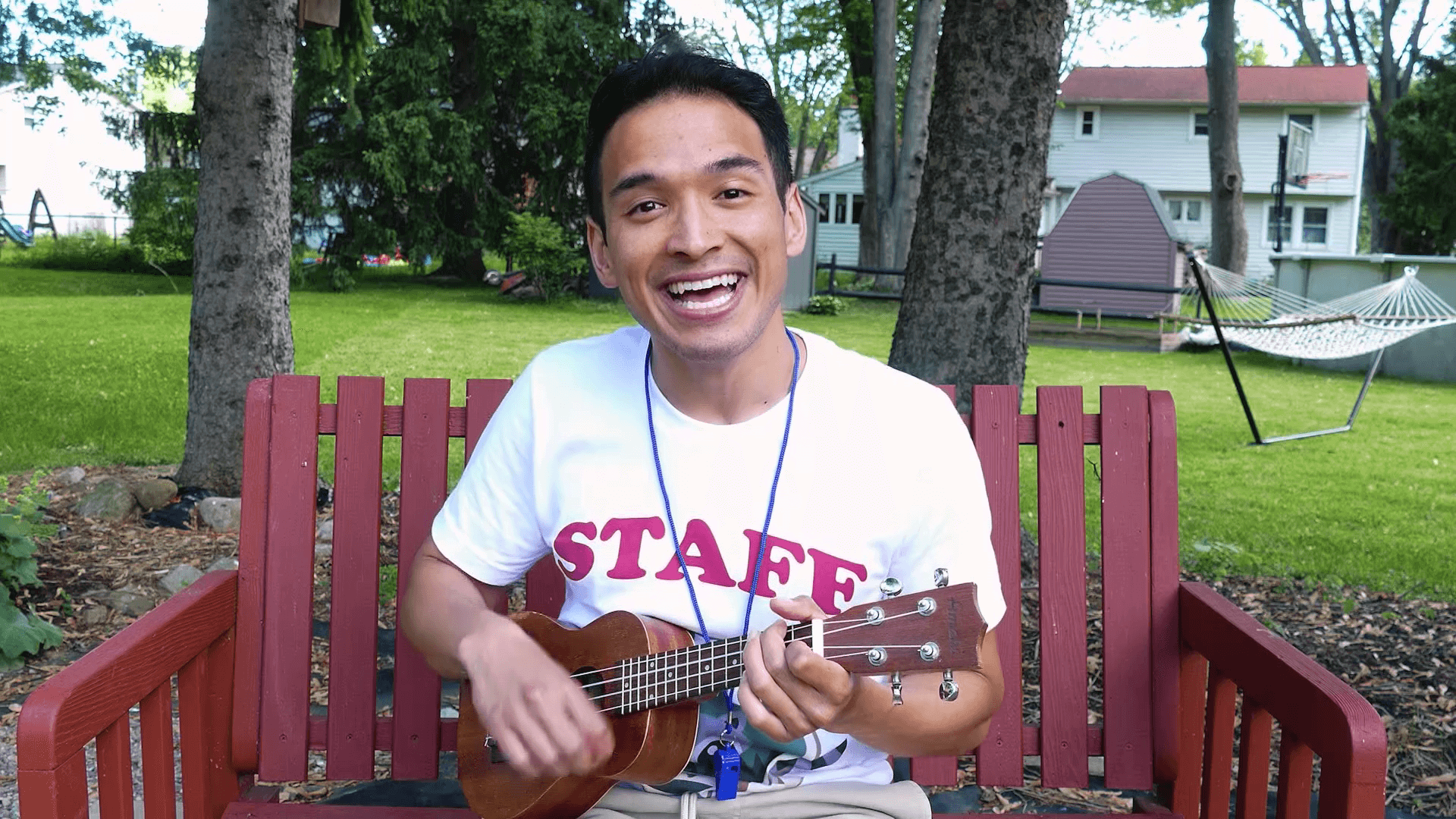 Camp TV host playing ukelele