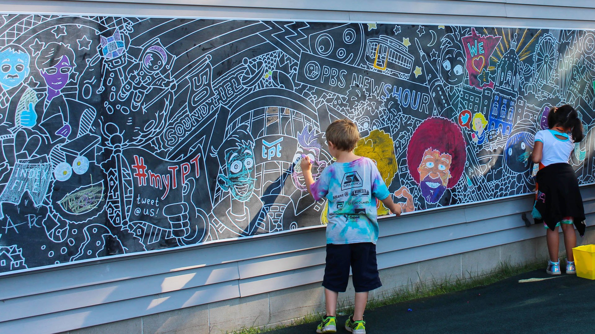 Kids coloring a mural