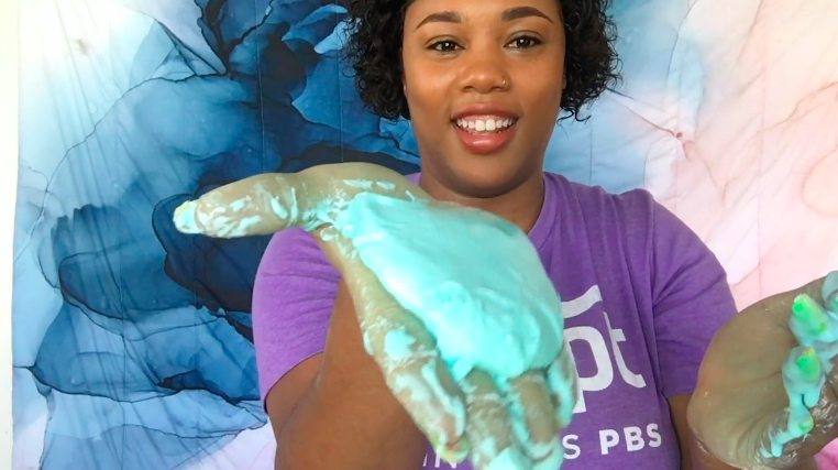 Woman with slime on hands