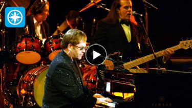 elton john on stage at piano