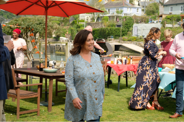 maggie cole walking through an outdoor party