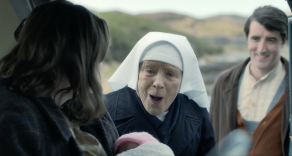 nun looking at woman holding baby in car