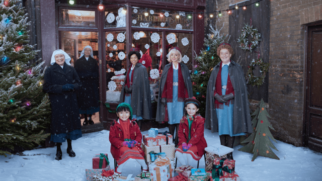 nurses and children gathered in a holiday scene