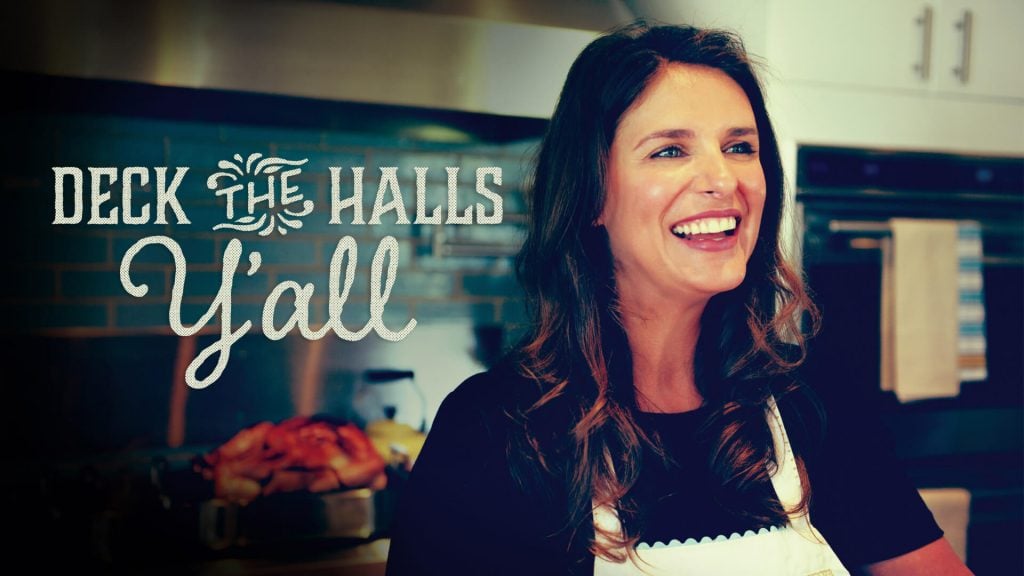 text: deck the halls y'al with a woman in an apron