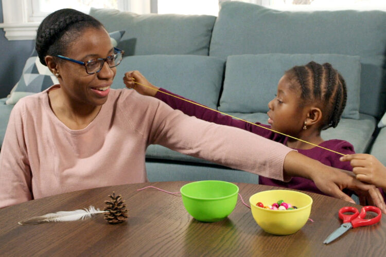 Mother and daughter make a necklace