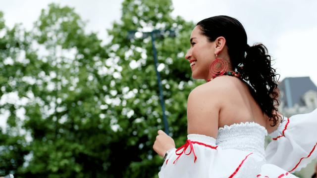Latino woman wearing white dress