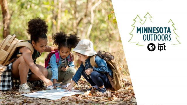 people hiking and looking at map with minnesota outdoors logo