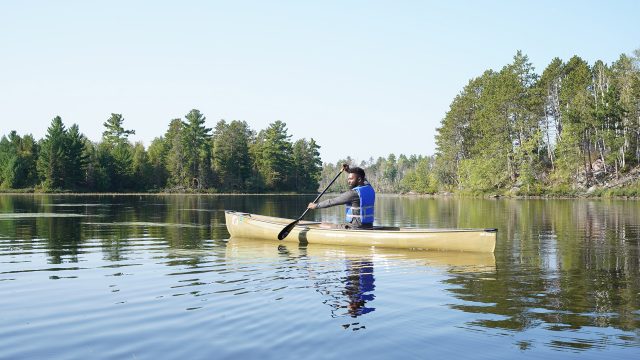 Baratunde paddles a boat