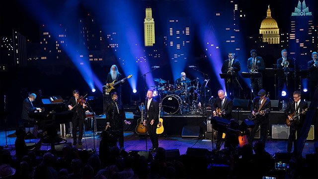 Lyle Lovett on stage with his large band