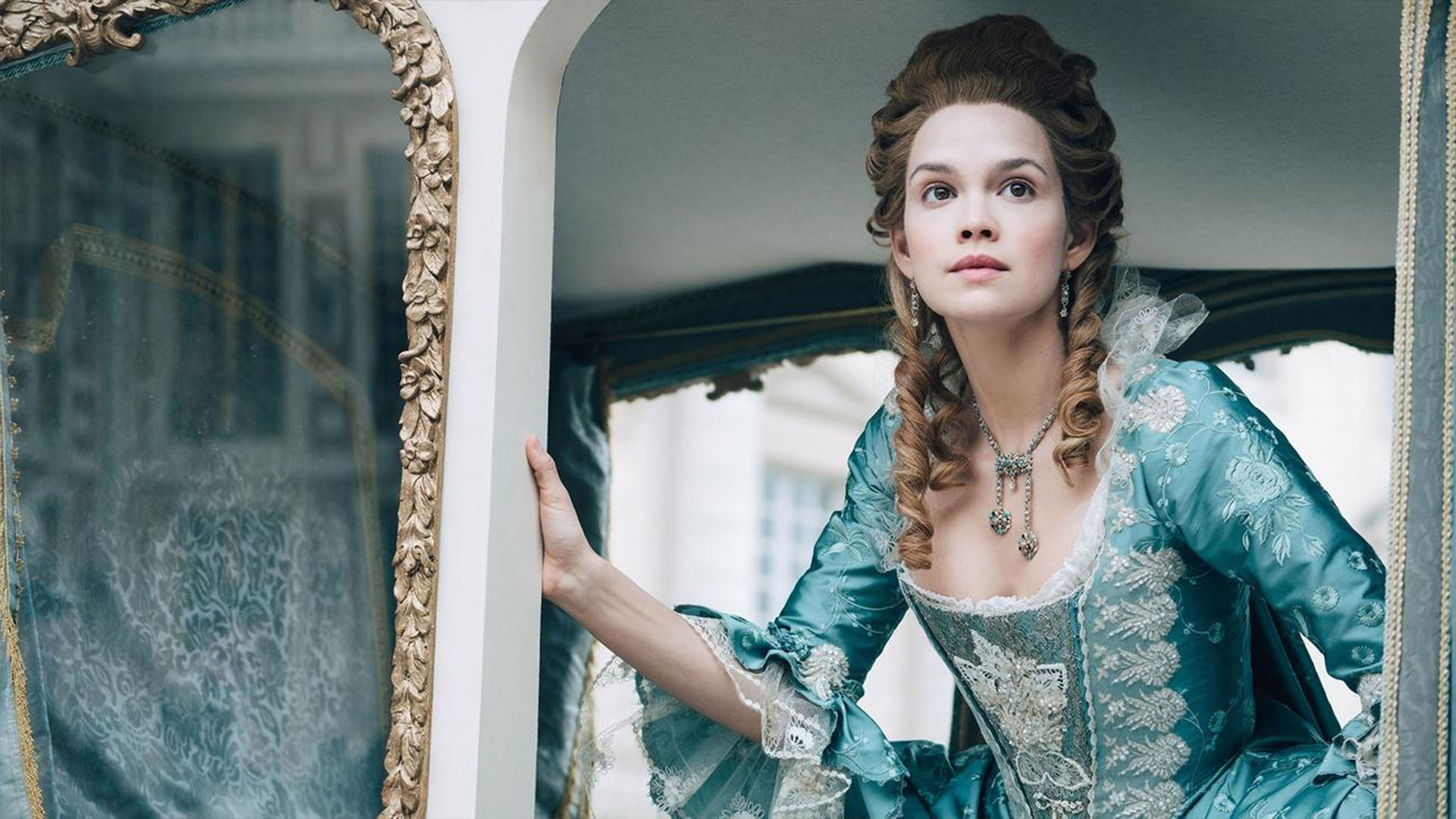 Marie Anoinette peers out of her carriage.
